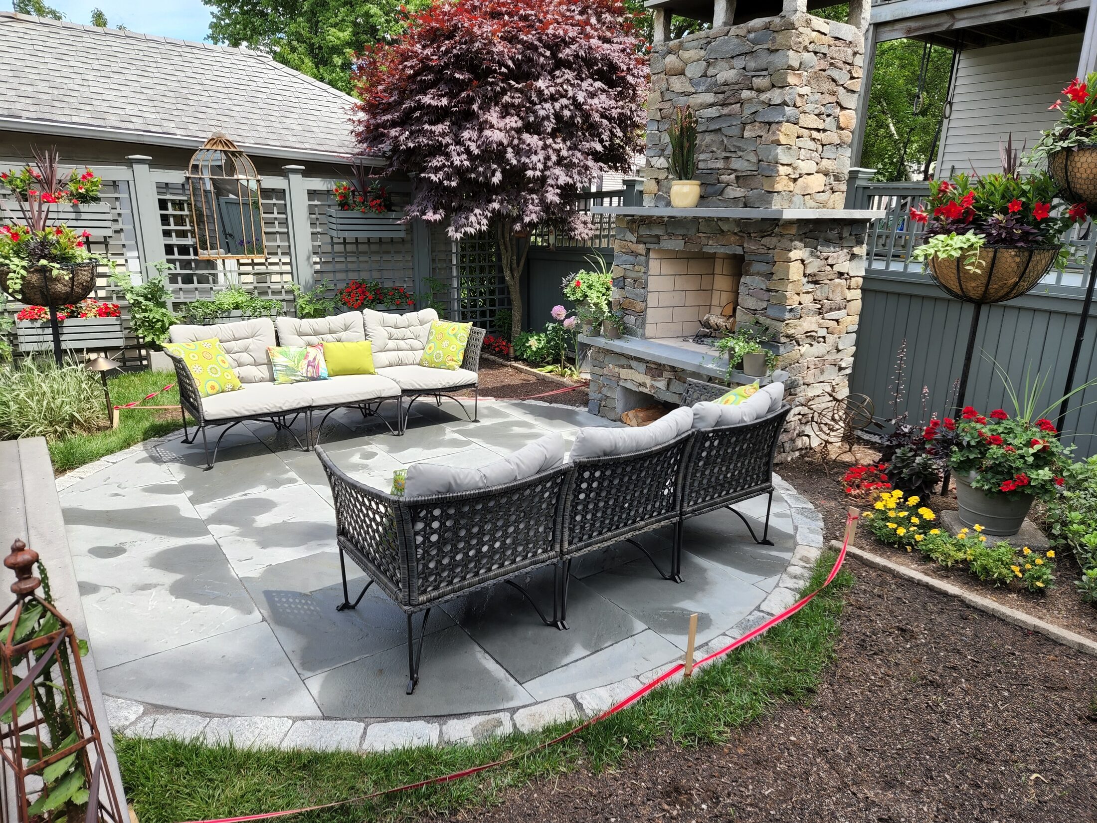 Natural-stone outdoor fireplace and curved patio in Quincy Massachusetts