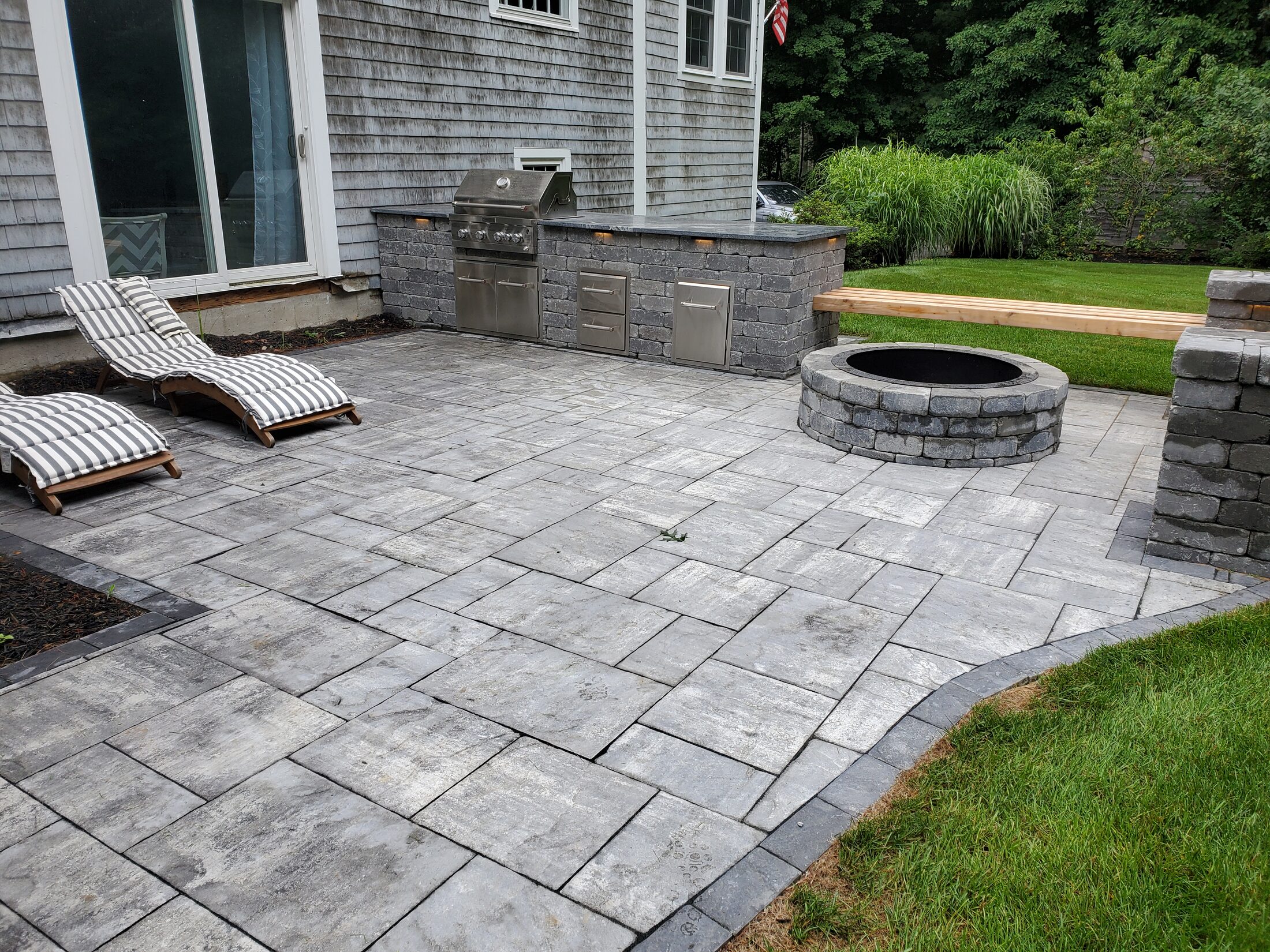 Duxbury patio with built-in seating and central fire pit