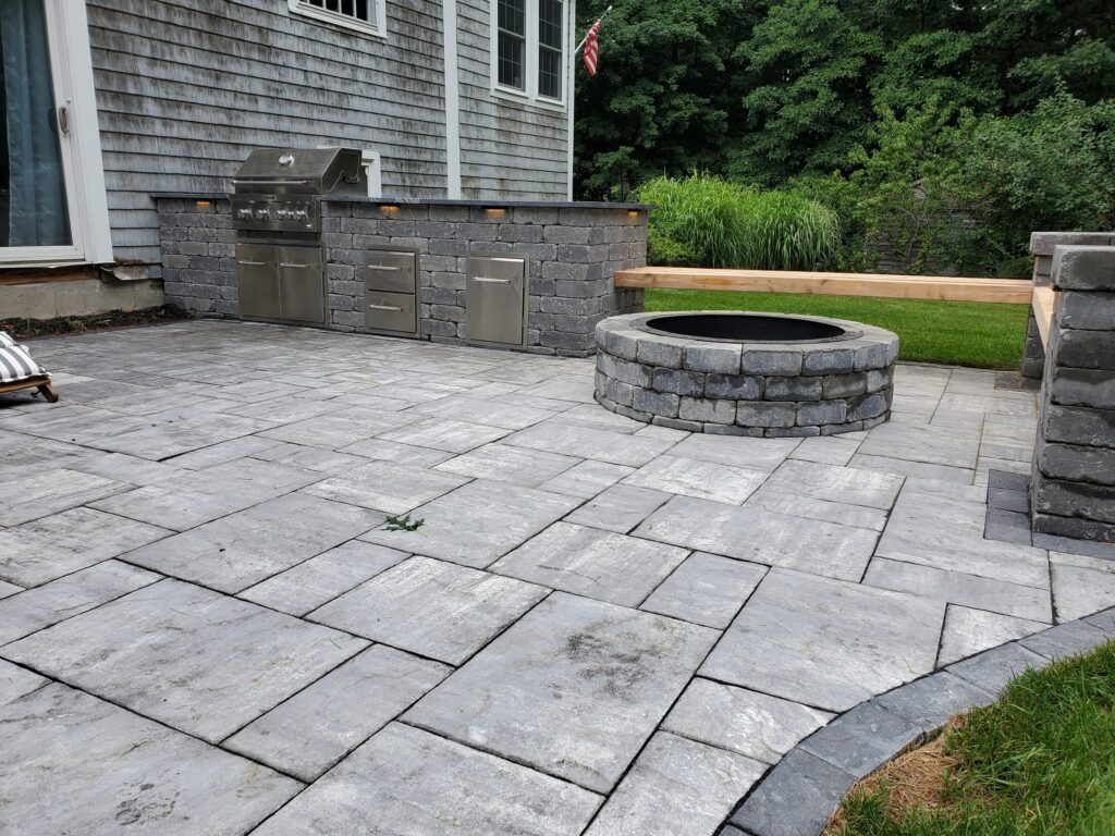 Duxbury patio layout with circular fire pit and outdoor kitchen