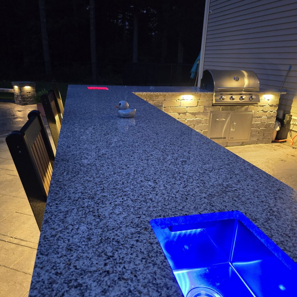Fire feature integrated into a Halifax outdoor kitchen counter