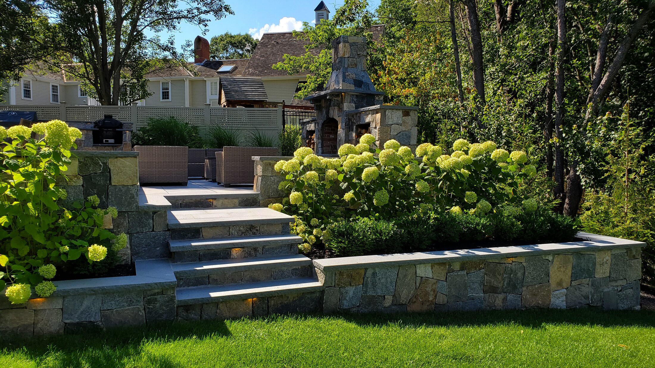 Natural-stone walls and broad steps in a Hingham landscape