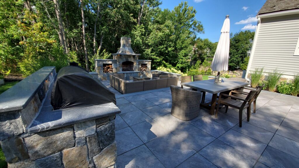 Upper Hingham patio with outdoor kitchen, masonry fireplace and dining area