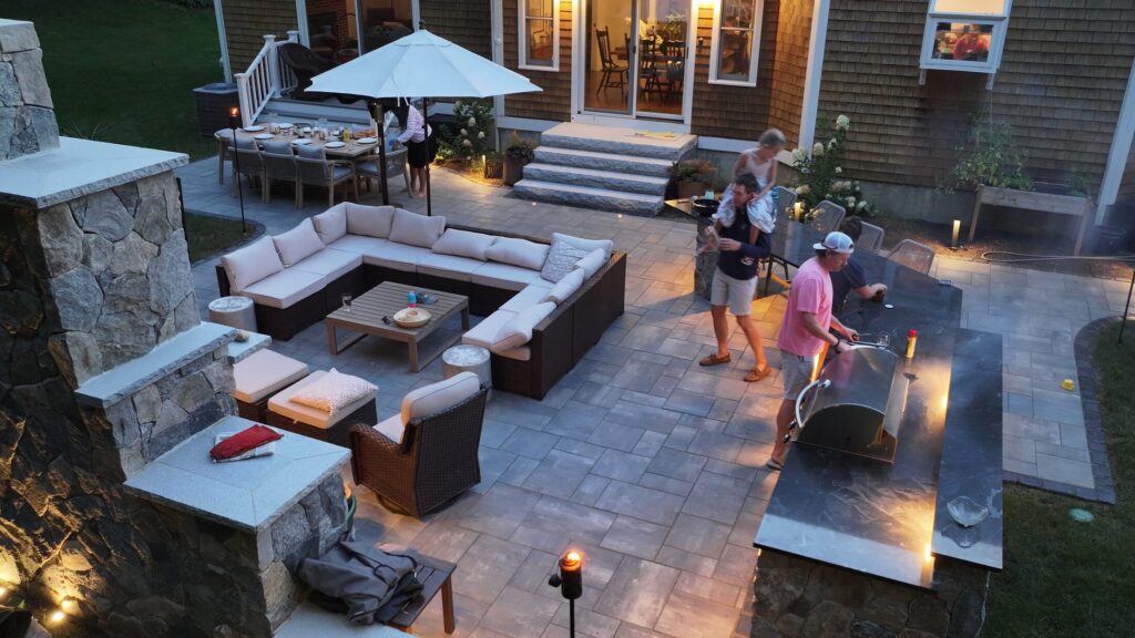 Elevated evening view across the Duxbury patio seating and outdoor kitchen
