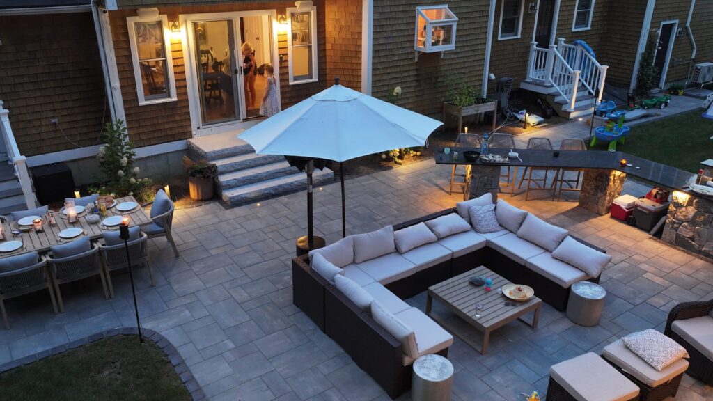 Aerial view of a complete Duxbury outdoor living space at dusk