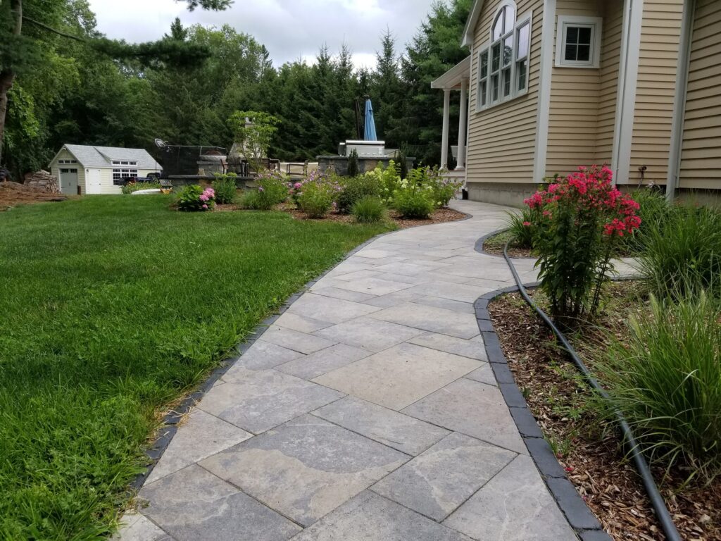 Curved stone walkway through an Easton garden