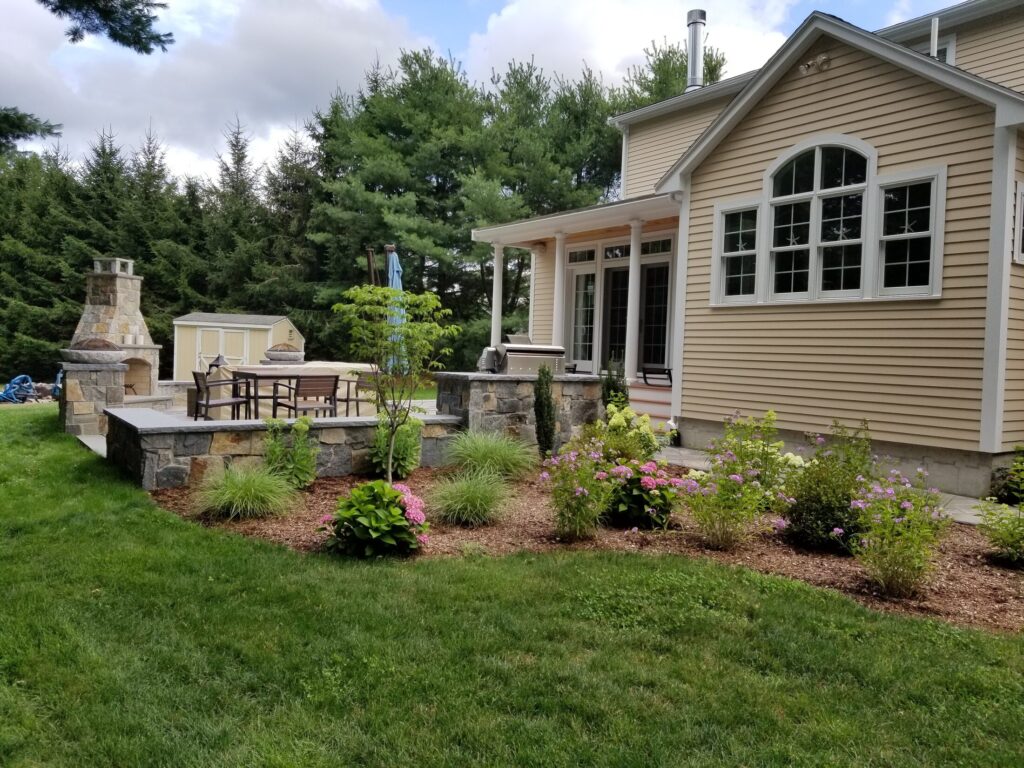 Finished Easton patio framed by lawn and planting beds