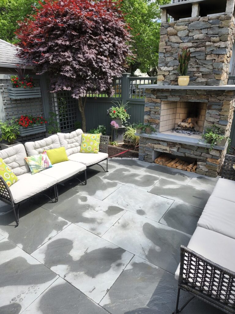 Intimate seating terrace arranged around the Quincy outdoor fireplace