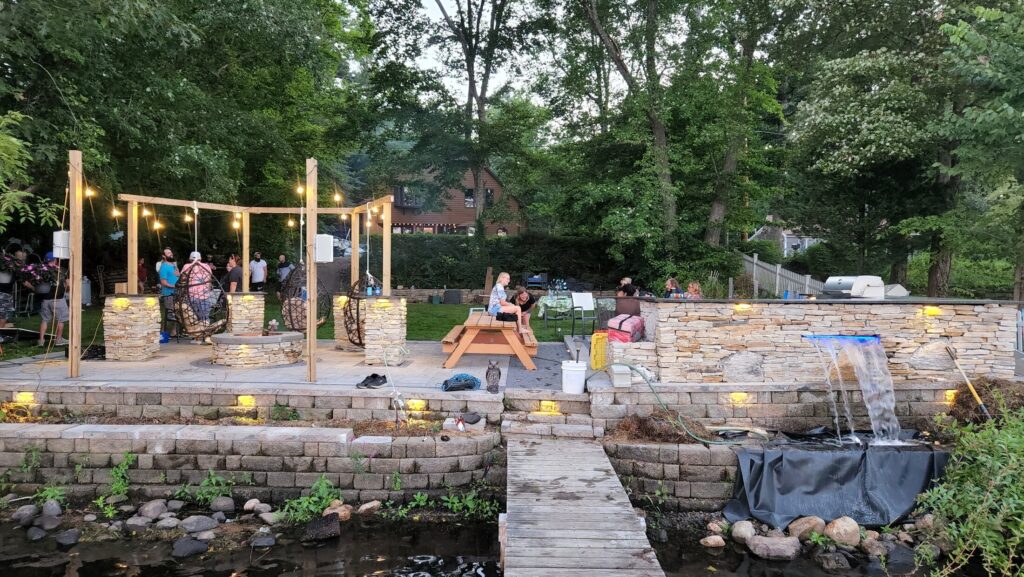 Wide view of the complete waterfront patio, masonry and shoreline setting