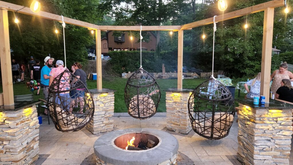 Masonry fire feature and illuminated seating area by the water